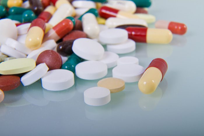 pile of different shaped and colored pills and capsules