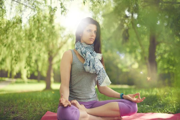 woman doing yoga in lovely park