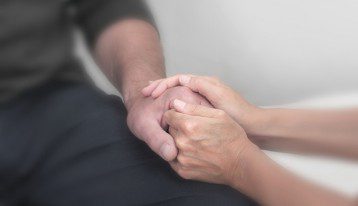 comforting someone - holding hands
