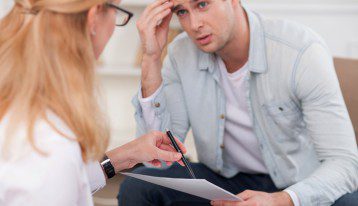 male college student talking to female counselor