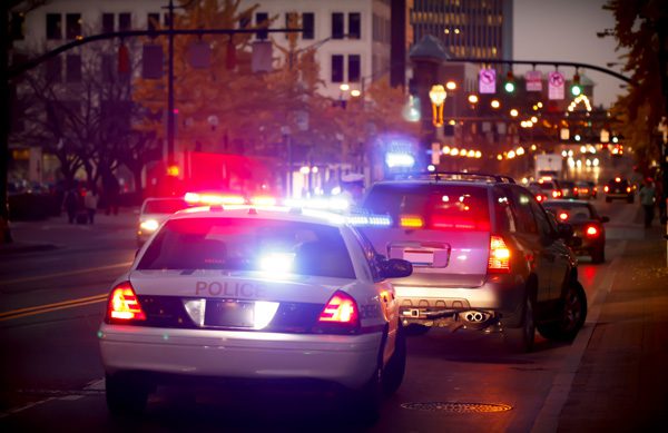 car on downtown street being pulled over by police