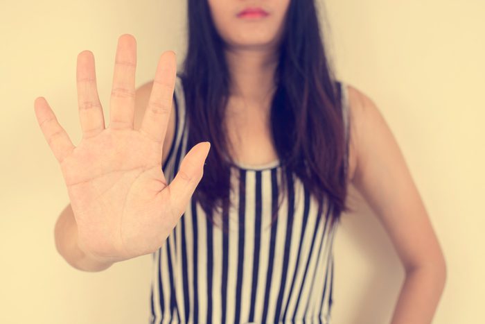 woman holding her hand up in a stop gesture