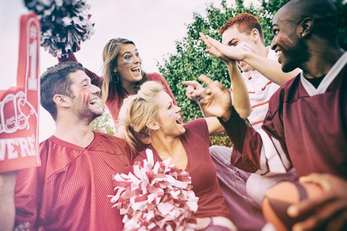 college students gathering - tailgating - all in same color of red and uniforms