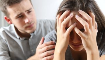 man trying to console upset woman