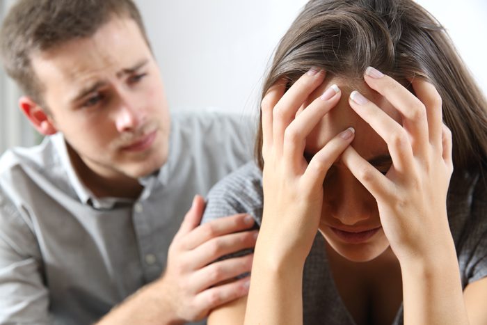 man trying to console upset woman