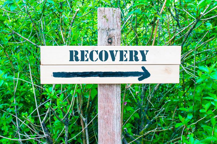 wooden recovery sign with arrow