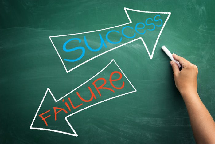 success and failure written on chalkboard