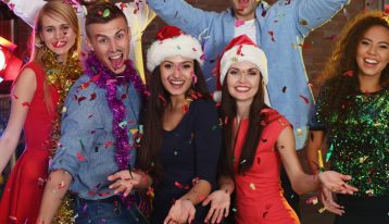 how to avoid, group of happy friends posing for camera at christmas party