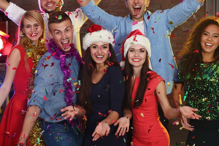 how to avoid, group of happy friends posing for camera at christmas party
