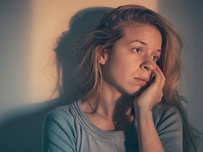 stigma of addiction, woman sitting alone depressed