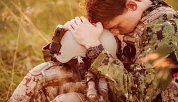 What Can Be Done to Help Veterans with Addiction, US soldier depressed sitting in field