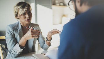 How to Talk to Your Employer About Rehab, man at work talking to female boss