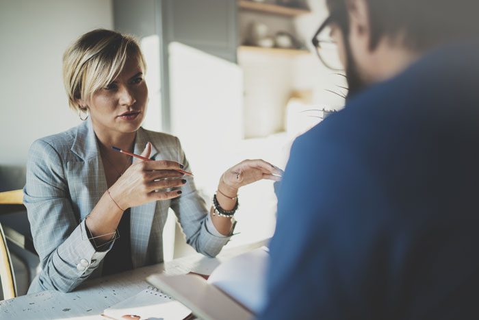 How to Talk to Your Employer About Rehab, man at work talking to female boss