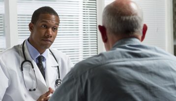 african american doctor speaking to his patient