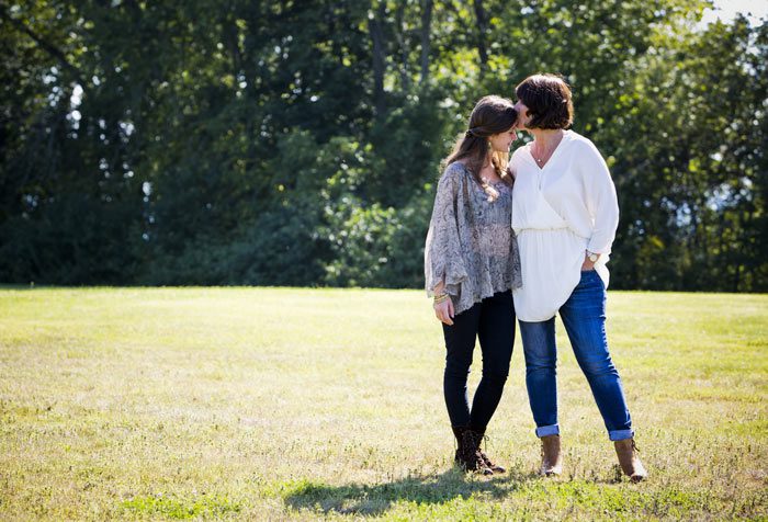 mom and young adult daughter being affectionate