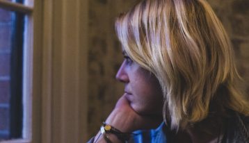 woman looking out window - detox