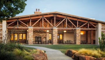 What to Expect at The Ranch at Dove Tree , Texas 12-Steps recovery treatment, addiction treatment in Texas, back patio view of facility with light bricks and wooden beam architecture