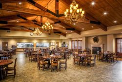 beautiful dining hall with chandeliers, and raised wooden beam ceiling