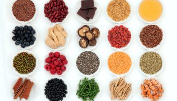 white bowls of super foods on white background - nutrition