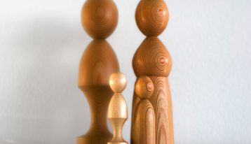 four wooden figurines on white background - family therapy