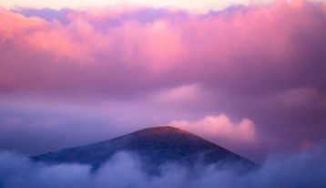 bright pink clouds over the top of a mountain - pink cloud experience