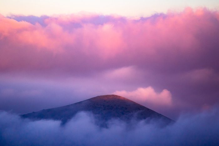 bright pink clouds over the top of a mountain - pink cloud experience