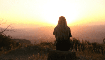 Woman sitting at overlook - Relapse