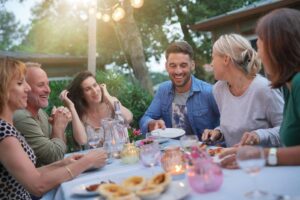 group of young adult friends having a wonderful garden party in the summer - sobriety strategies