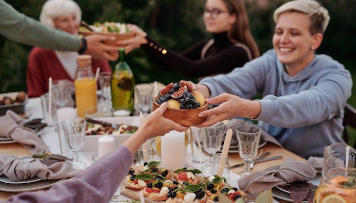 friends table Thanksgiving food drinking laughing