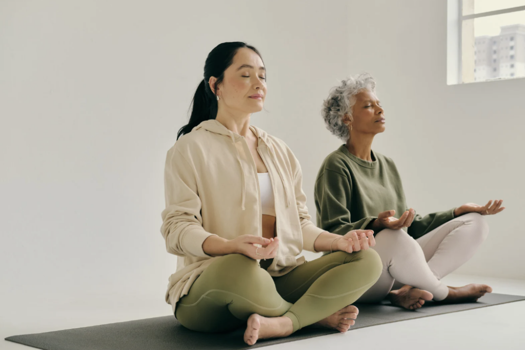 Two women in meditative poses.
